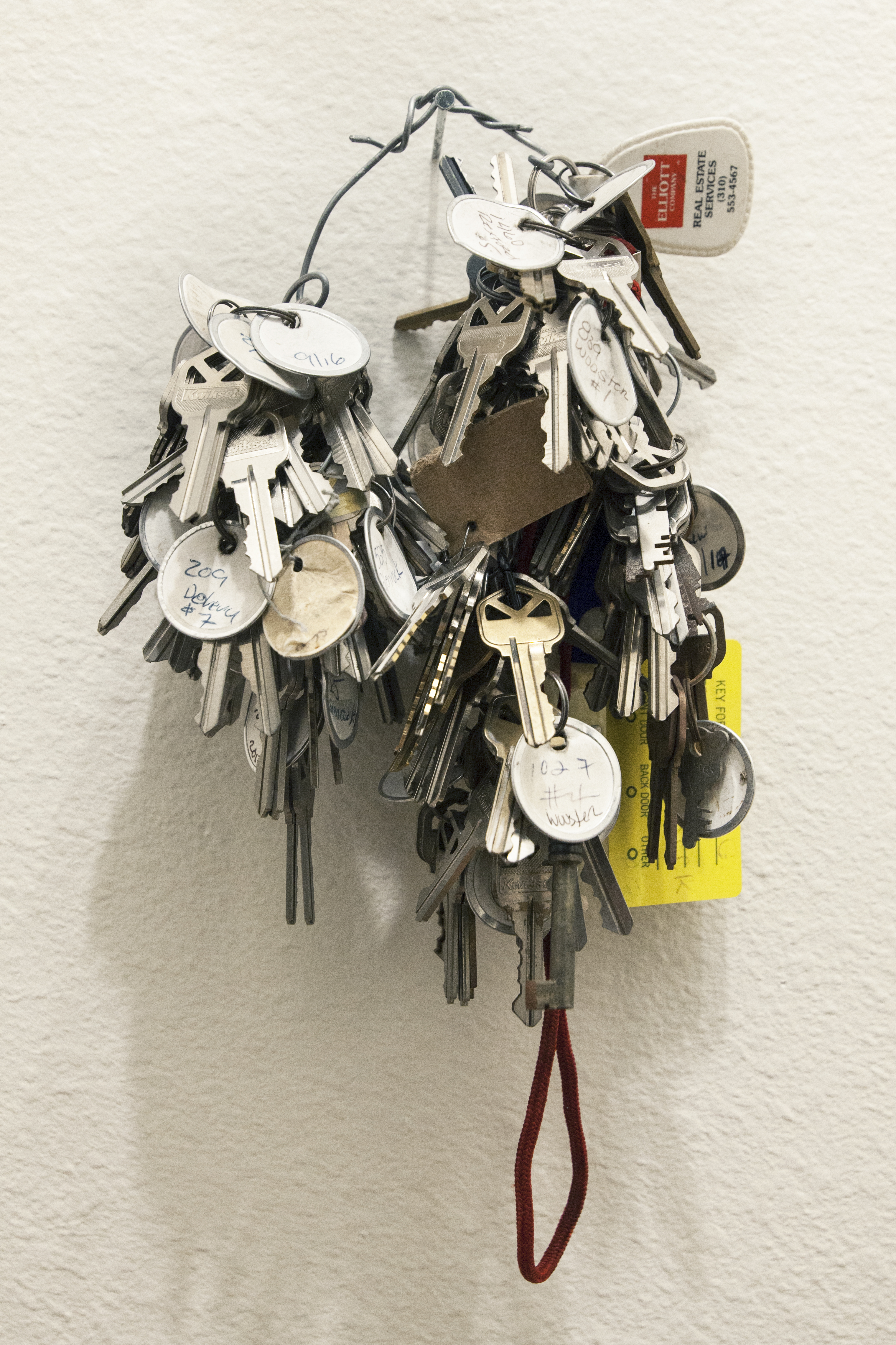A ring with a large volume of keys on it hung on the wall